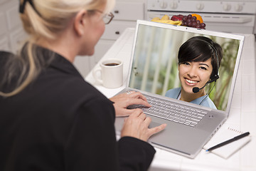 Image showing Woman In Kitchen Using Laptop - Online with Nurse or Doctor