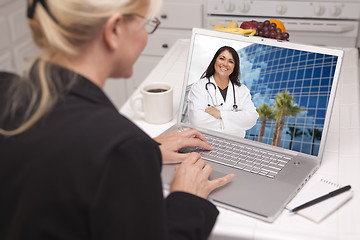 Image showing Woman In Kitchen Using Laptop - Online with Nurse or Doctor