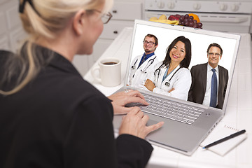 Image showing Woman In Kitchen Using Laptop, Online with Nurses or Doctors