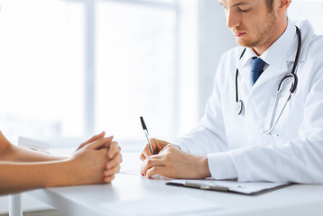 Image showing patient and doctor taking notes