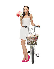 Image showing country girl with bicycle and flowers