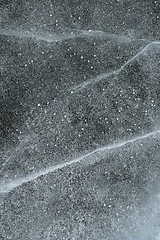 Image showing Grainy snow covering cracked ice