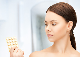 Image showing young woman with pills