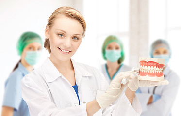 Image showing doctor with toothbrush and jaws in hospital