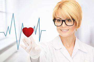 Image showing doctor pressing virtual button with heart diagram