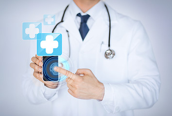 Image showing doctor holding smartphone with medical app