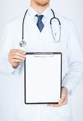 Image showing doctor holding blank white paper