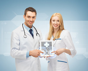 Image showing young doctors pointing at tablet pc