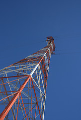 Image showing Red and white power tower in the blue sky