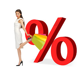 Image showing woman with shopping bags and percent signs