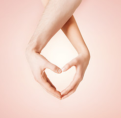 Image showing woman and man hands showing heart shape