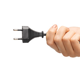 Image showing hand holding black electrical plug with wire