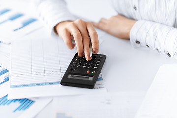 Image showing woman hand with calculator and papers