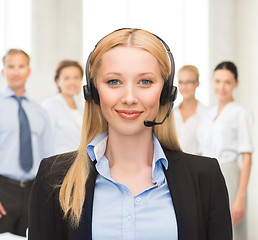 Image showing helpline operator with headphones in call centre