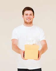 Image showing man in white t-shirt with gift box