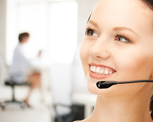 Image showing helpline operator with headphones in call centre