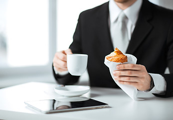 Image showing man with tablet pc and cup of coffee