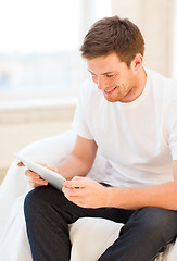 Image showing man working with tablet pc at home