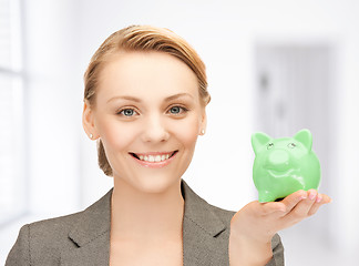 Image showing lovely woman with small piggy bank