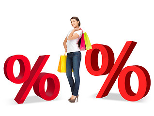 Image showing woman with shopping bags and percent signs