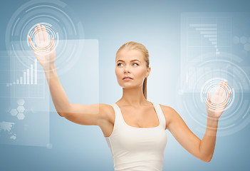 Image showing businesswoman touching virtual screen