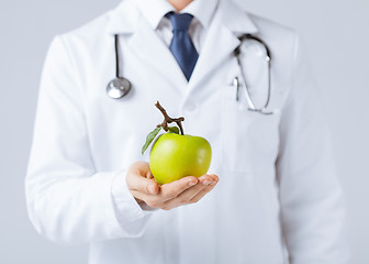 Image showing male doctor with green apple
