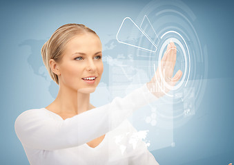 Image showing businesswoman touching virtual screen