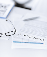 Image showing signed contract paper with glasses