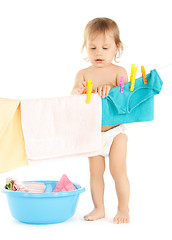 Image showing baby doing laundry