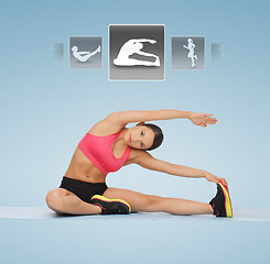 Image showing woman stretching on the floor