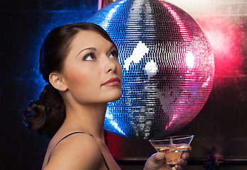 Image showing woman with cocktail and disco ball