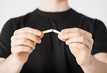 Image showing man breaking the cigarette with hands