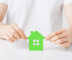 Image showing hands holding green house