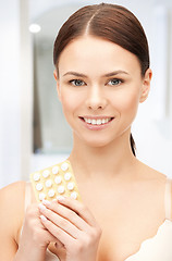 Image showing young beautiful woman with pills