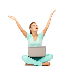 Image showing happy girl sitting on the floor with laptop