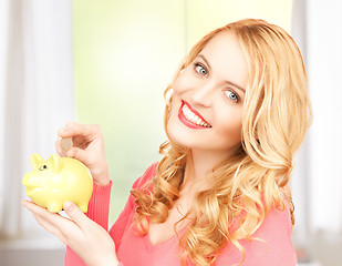 Image showing woman with piggy bank and cash money