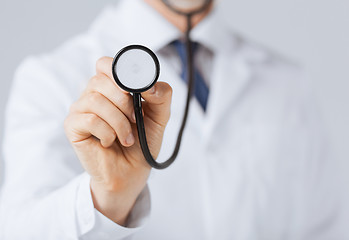 Image showing doctor hand with stethoscope listening something