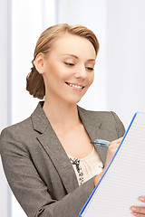 Image showing happy woman with big notepad