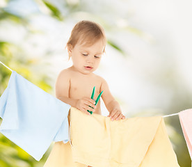 Image showing baby doing laundry