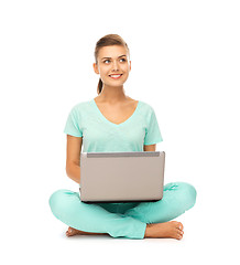 Image showing young girl sitting on the floor with laptop