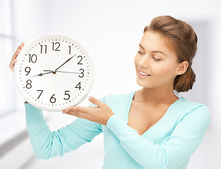 Image showing woman with wall clock