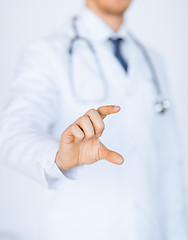 Image showing male doctor holding something in his hand