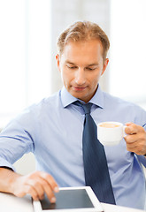 Image showing businessman with tablet pc and coffee in office