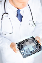 Image showing male doctor holding tablet pc with medical app