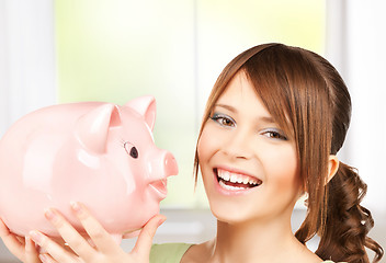 Image showing lovely girl with big piggy bank