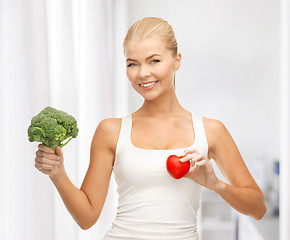 Image showing woman holding heart symbol and broccoli