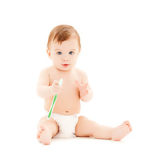 Image showing curious baby brushing teeth