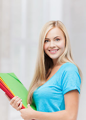 Image showing smiling student with folders