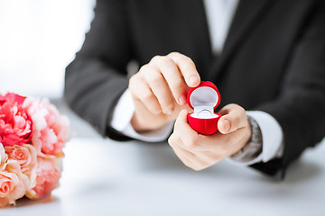 Image showing man with gift box and wedding ring