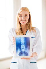 Image showing female doctor with x-ray on tablet pc